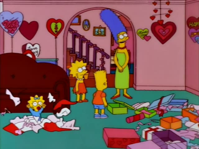 Lisa and Bart stand in the pink living room with Marge, who wears a green dress and has a tall blue beehive, while Maggie…