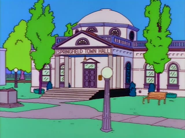 Bart, Marge, Lisa and baby Maggie sit around a breakfast table in the kitchen, then the scene cuts to the exterior…