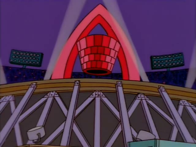 Homer starts out running past a trailer in an indoor arena with a red stage arch and spotlights overhead, then walks…