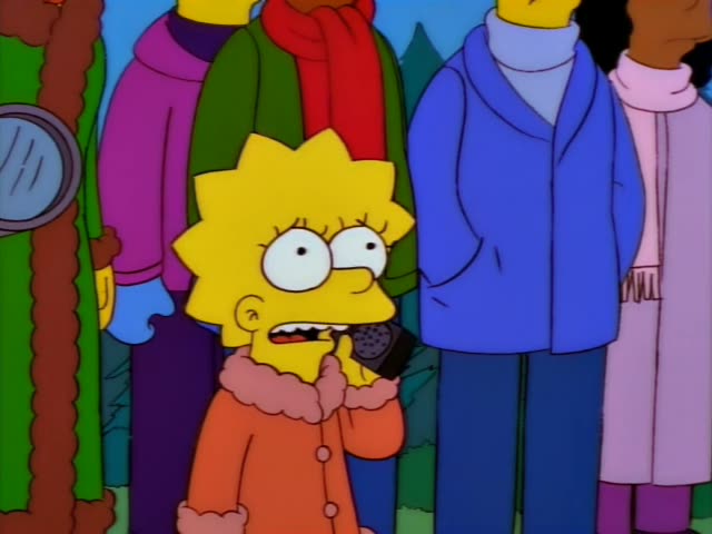 Lisa stands in a crowd of bundled-up onlookers holding a walkie-talkie to her mouth at first, and she speaks into it…