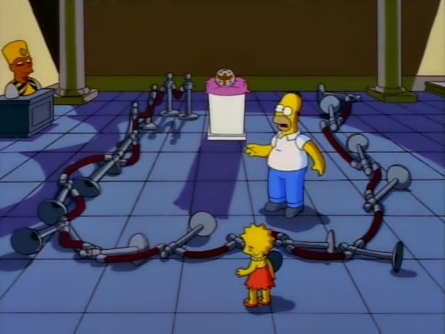 Homer and Lisa Simpson stand in an Egyptian-themed museum hall, with Lisa in her red dress and pearl necklace and Homer…