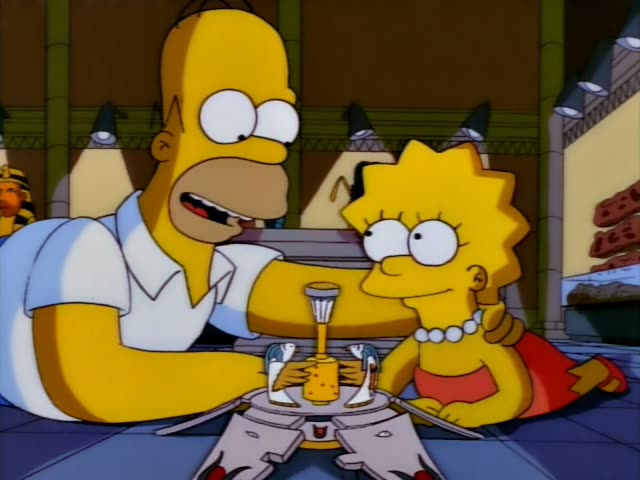 Homer and Lisa sit at a low table in an Egyptian-style room with pharaoh statues and a stone wall behind them, with Lisa's…