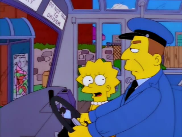 Lisa Simpson stands beside the bus driver in a blue uniform and cap as he steers, and she leans in with her hands…