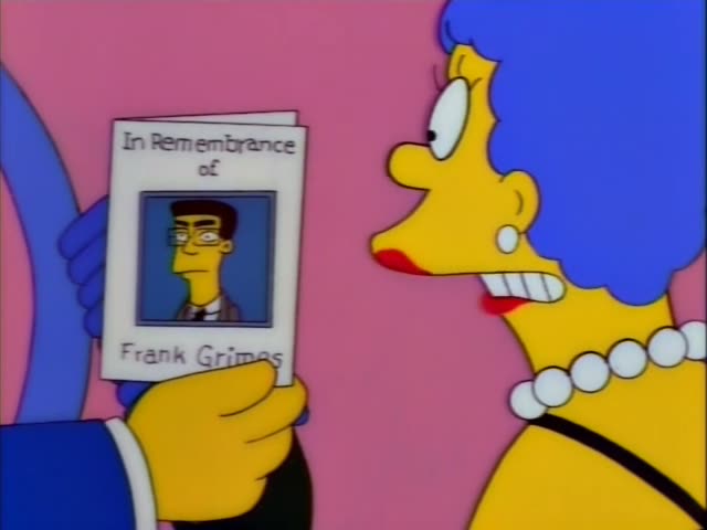 Marge and Homer in a blue suit and green tie stand in a pink room