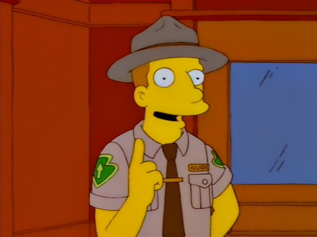 A tour guide in a grey hat and khaki uniform with a GUIDE badge gestures toward a door marked GIFT SHOP, then pulls it open…