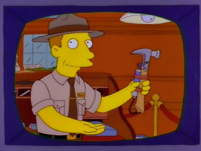 Homer, Bart, and Marge stand on a pink-walled room with Marge holding baby Maggie, who has a pacifier and blue bow…
