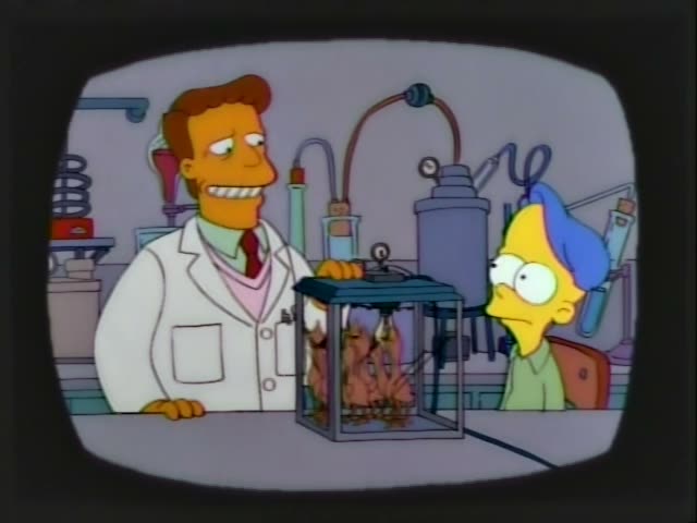 A man in a white lab coat with reddish-brown hair and a red tie stands beside a blue-haired boy in a green shirt…