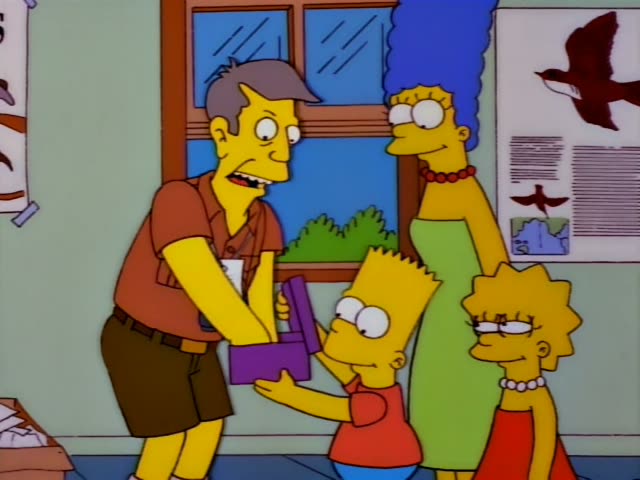 Homer, Marge, Bart and Lisa stand at a wooden counter in a room with bird posters, a window and a ceiling of tiles…