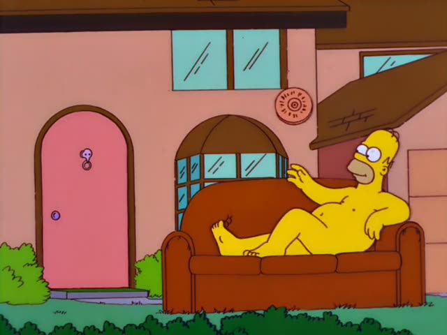 Homer lounges on a red couch in front of a pink house, holding a round sign with partly visible lettering, while Marge opens…