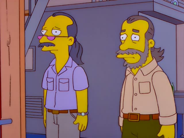 Two men who are not Simpsons regulars stand side by side indoors near a door on the left edge, beside a grey wall…