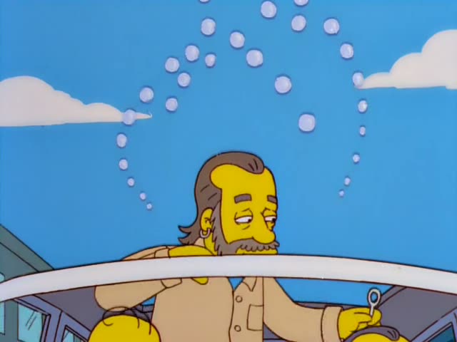 Ned Flanders stands on a city sidewalk beside a van painted with flowers and the word LOVE, while Homer leans out…