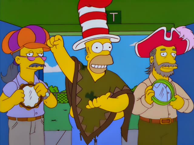 Homer stands between a man in an orange-and-purple cap with pink glasses and a bearded man in a red feathered pirate hat…