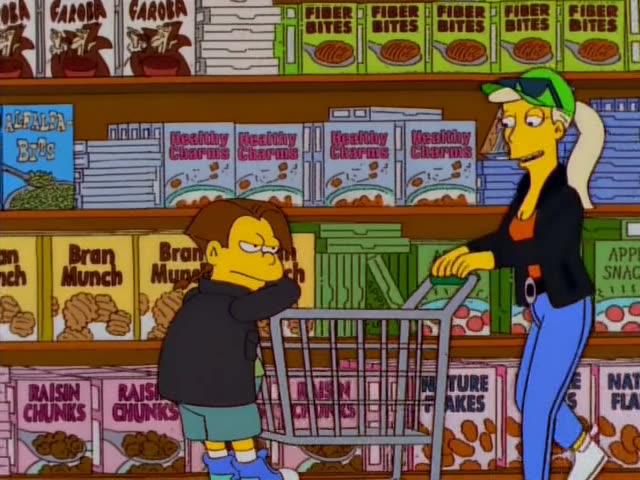 In a supermarket cereal aisle, a blond woman in a green cap, black jacket and blue jeans pushes a shopping cart…