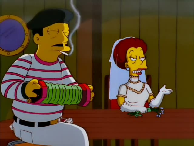 A man in a black beret and striped shirt smokes a cigarette while playing an accordion at a wooden table, and a red-haired…