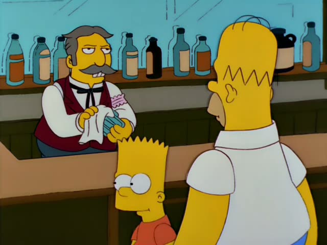 Moe wipes a glass with a white cloth behind a bar lined with bottles while Bart in an orange-red shirt and Homer in a white…