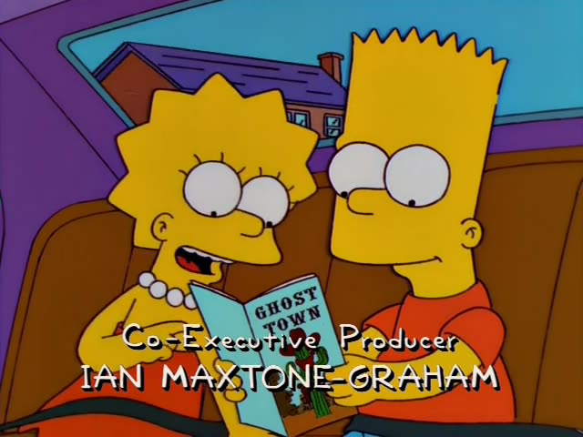 Lisa and Bart sit side by side in the back seat of the family car, reading a booklet titled "Ghost Town" with a cactus…