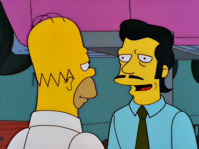 Homer stands with his back partly turned, facing a mustached man with slicked-back black hair, a light blue shirt and a dark…
