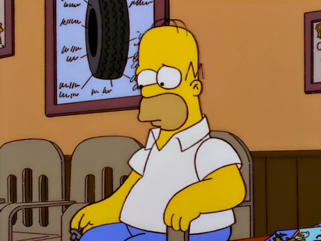 Homer sits in a tire shop waiting area beneath a TIRES poster, first fiddling with a small silver wheel weight…