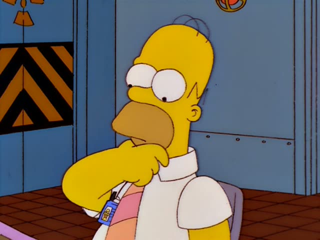 Homer Simpson first stands rubbing his chin at a control console in a blue-walled plant room while a group of men waits…
