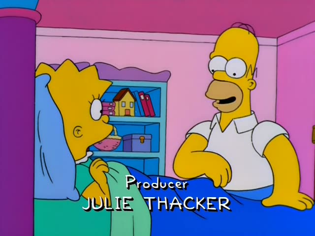 Homer sits on the edge of a bed in a pink room beside Lisa, who lies under a green blanket with her spiky hair on a blue…