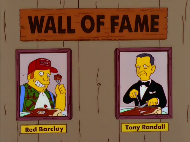 Red Barclay sits at a diner table holding a forkful of meat, while Homer sits beside him