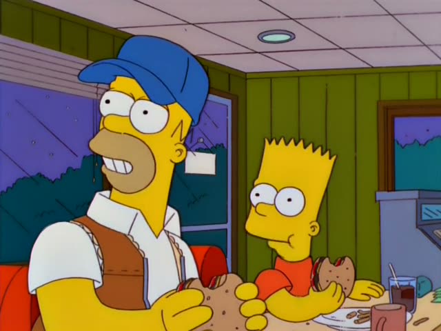 Homer sits in a green-paneled diner booth holding a large sandwich, while Bart in an orange shirt sits beside him eating…
