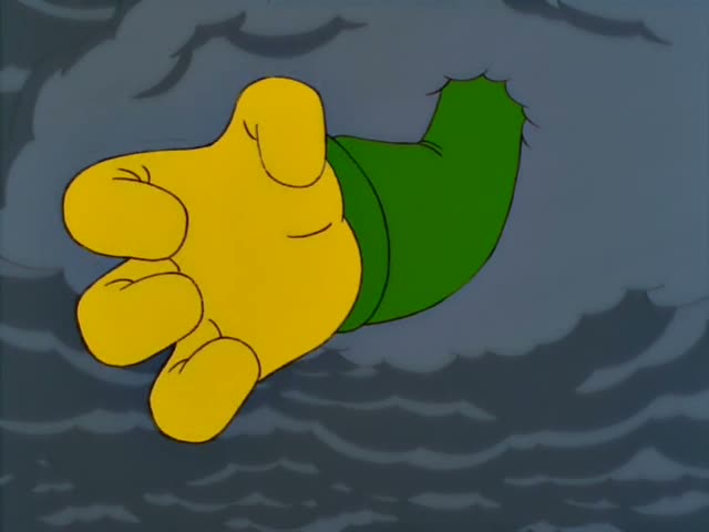 A giant disembodied cartoon hand with a green sleeve drifts through a stormy grey sky over a grassy field bordered by a tall…